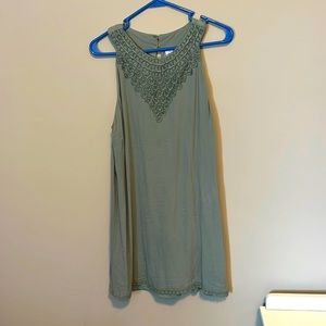 Green dress with lace design around the top